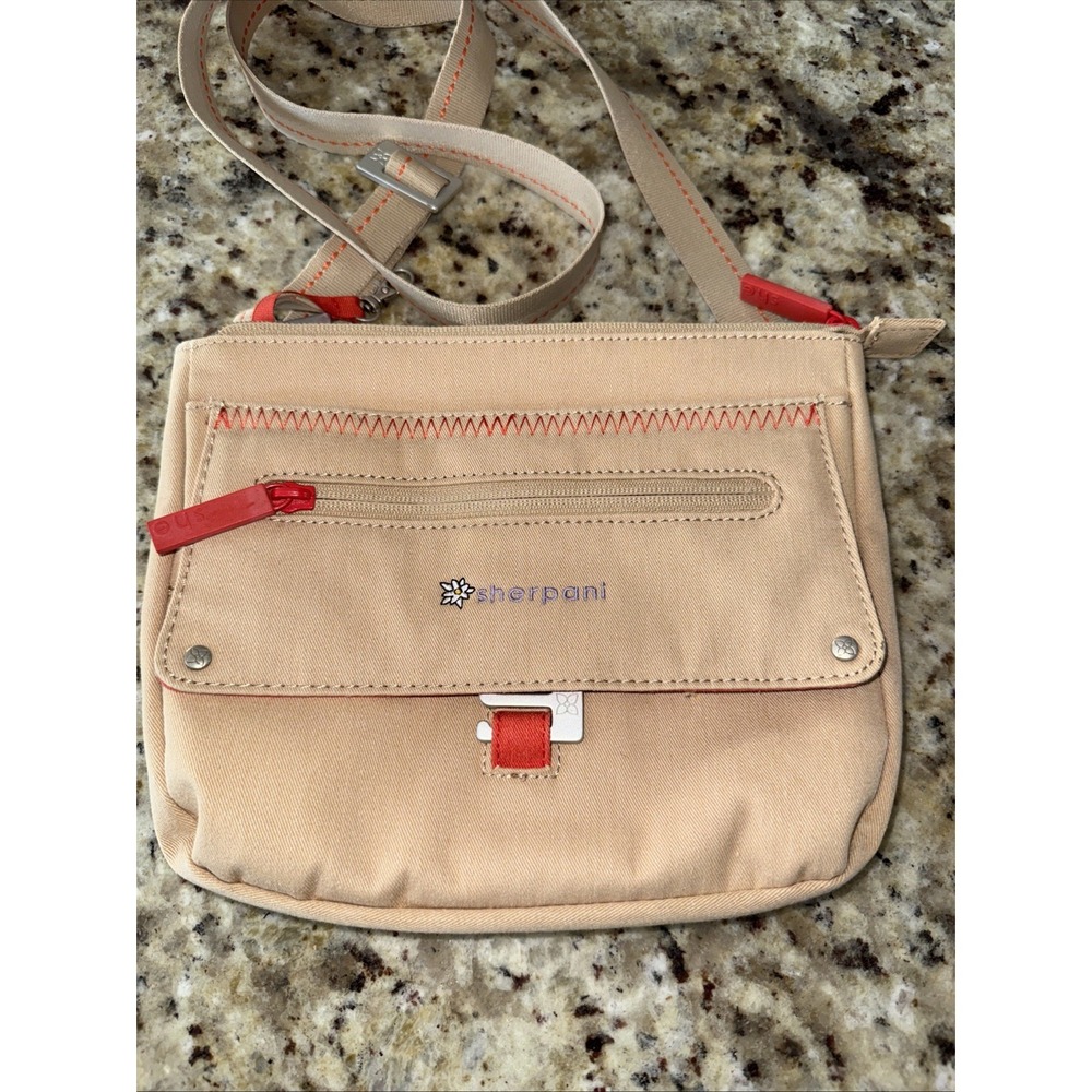 Sherpani tan canvas purse with flower detail and‎ orange Lots Of Pockets4369